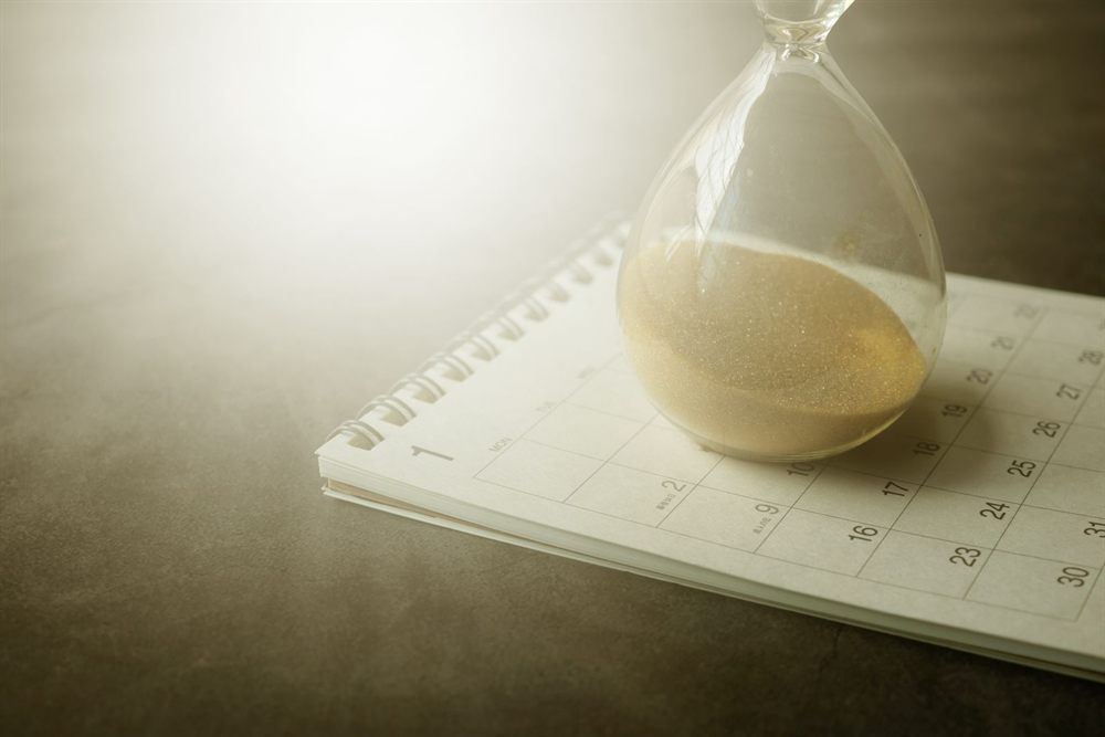 Hourglass resting on a calendar page