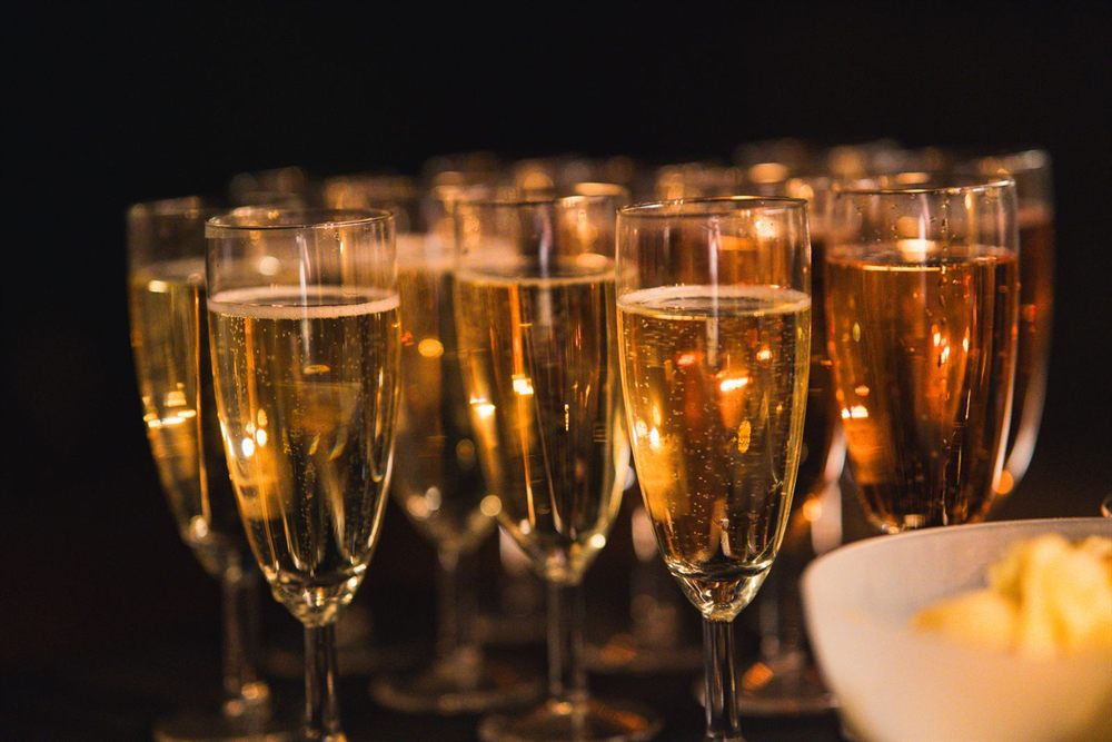 Rows of champagne glasses with sparkling bubbles at a celebration