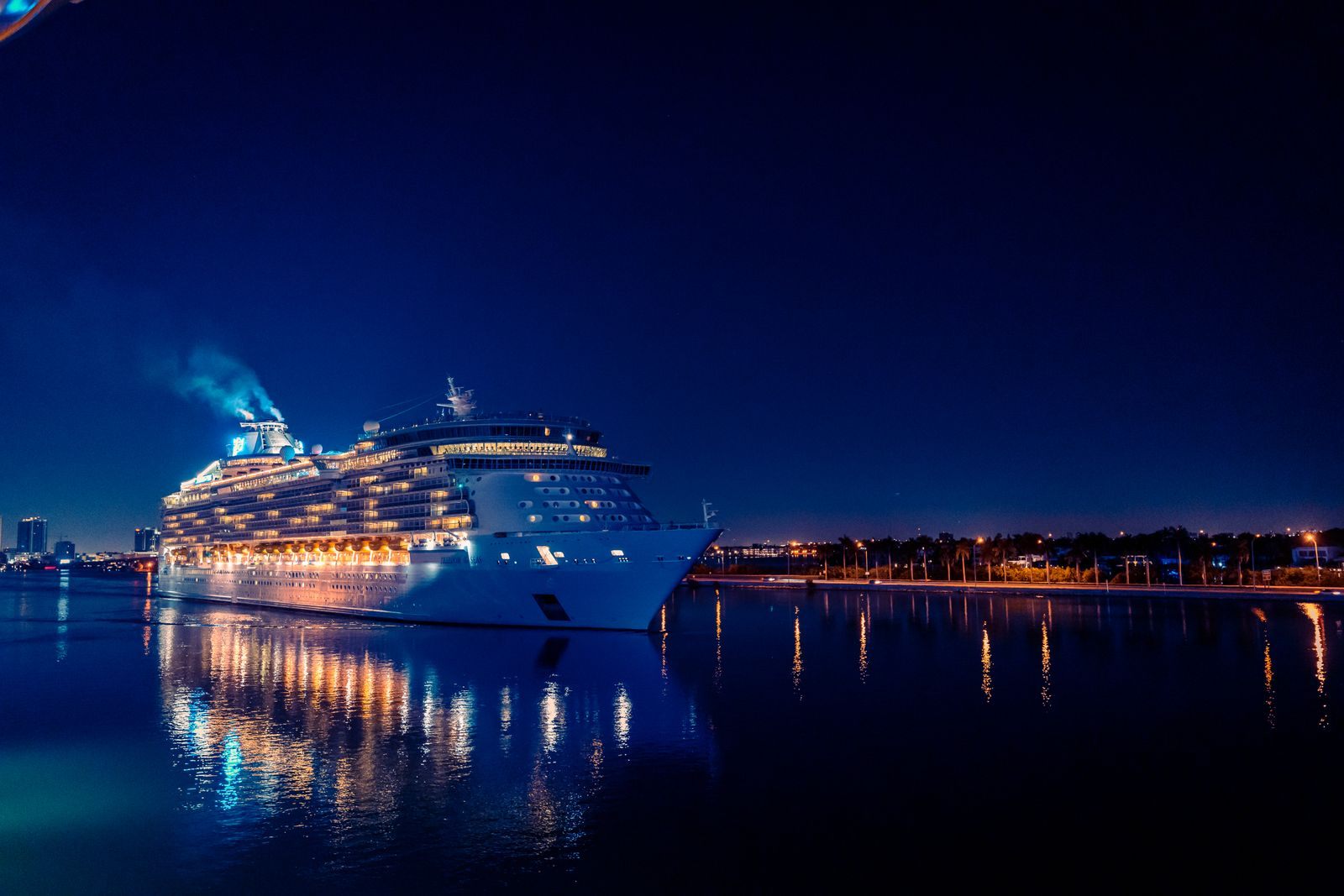 Large cruise ship lit up at night in Miami